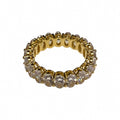 Gold ring with clear gemstones on a white background