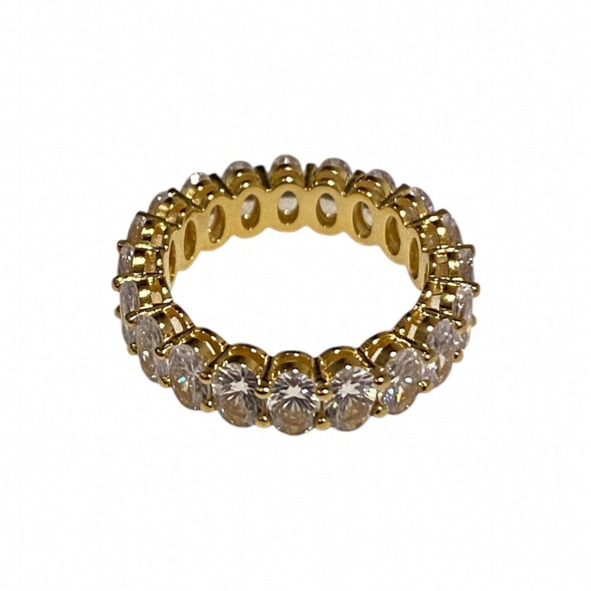 Gold ring with clear gemstones on a white background