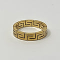 Gold ring with a geometric pattern on a white background