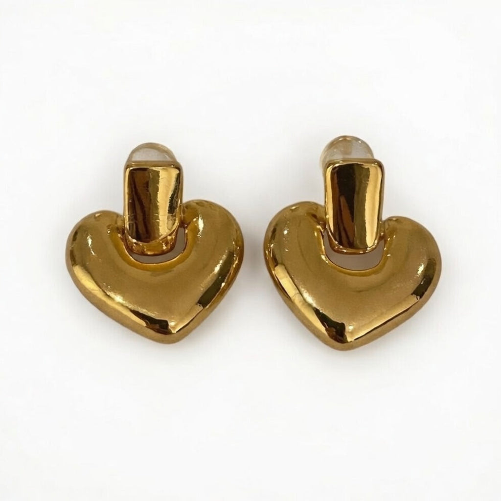 Pair of gold heart-shaped earrings on a white background