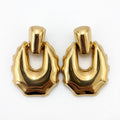 Pair of gold hoop earrings on a white background