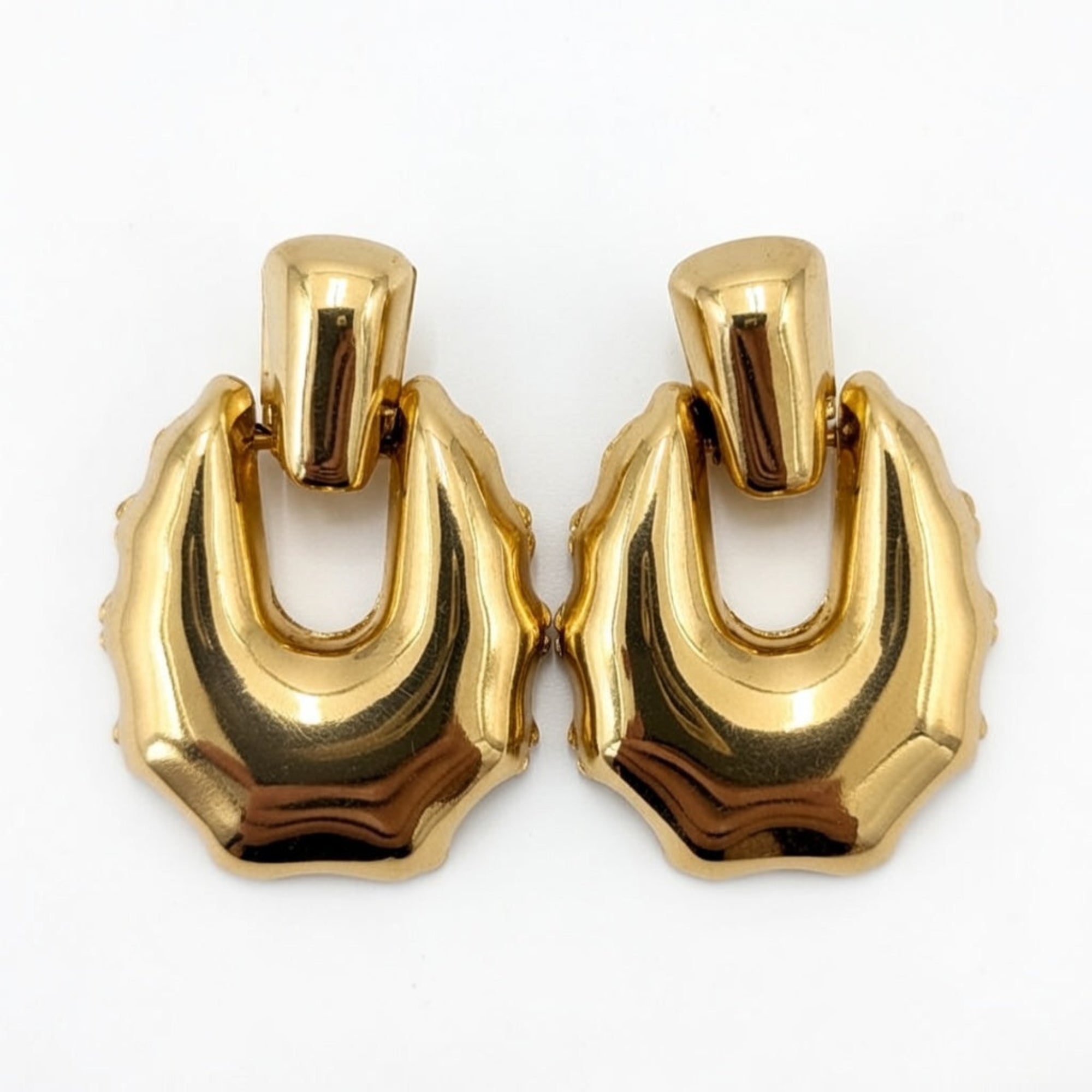 Pair of gold hoop earrings on a white background
