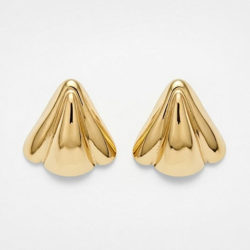 Pair of gold cone-shaped earrings on a light gray background