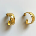 Pair of gold hoop earrings on a white background