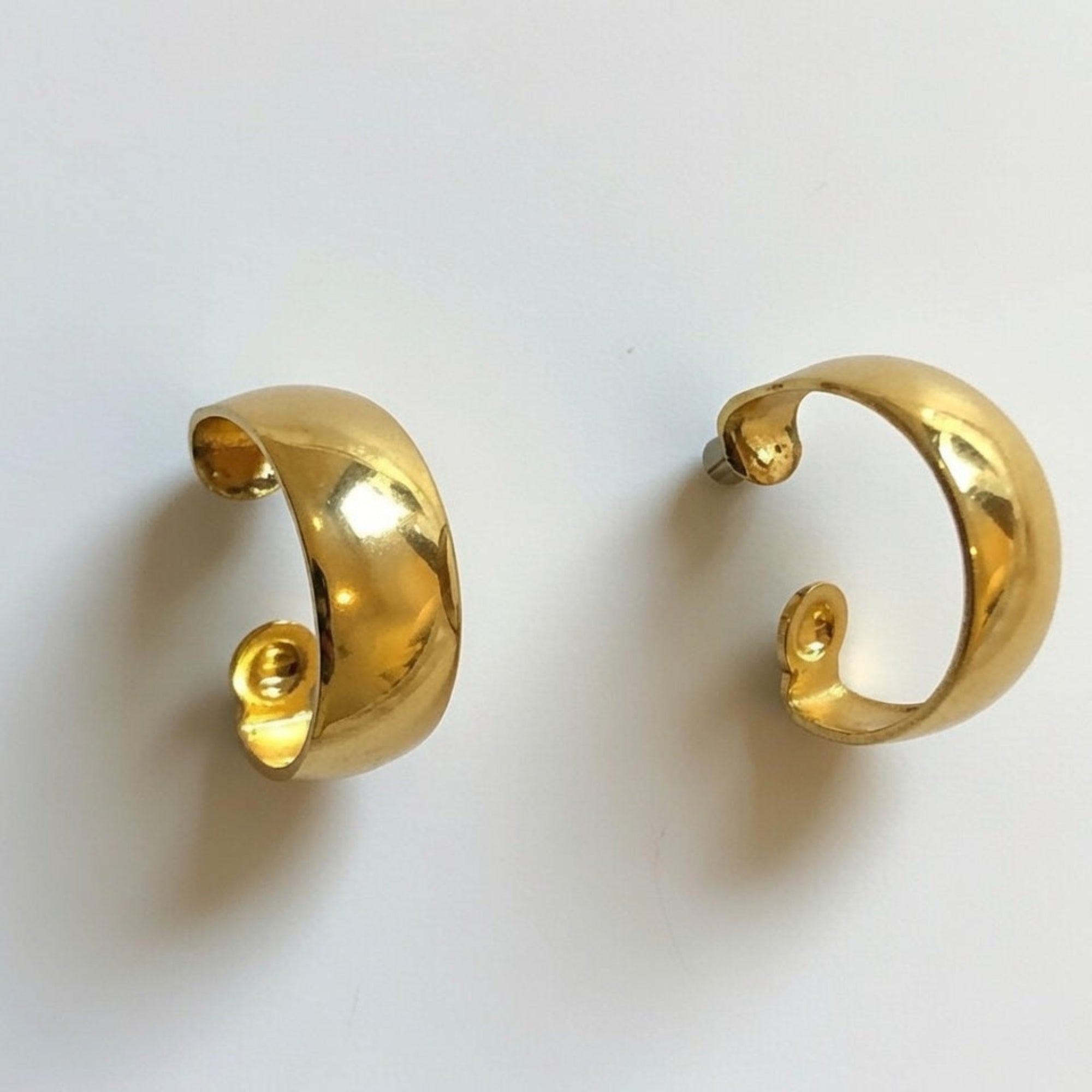 Pair of gold hoop earrings on a white background