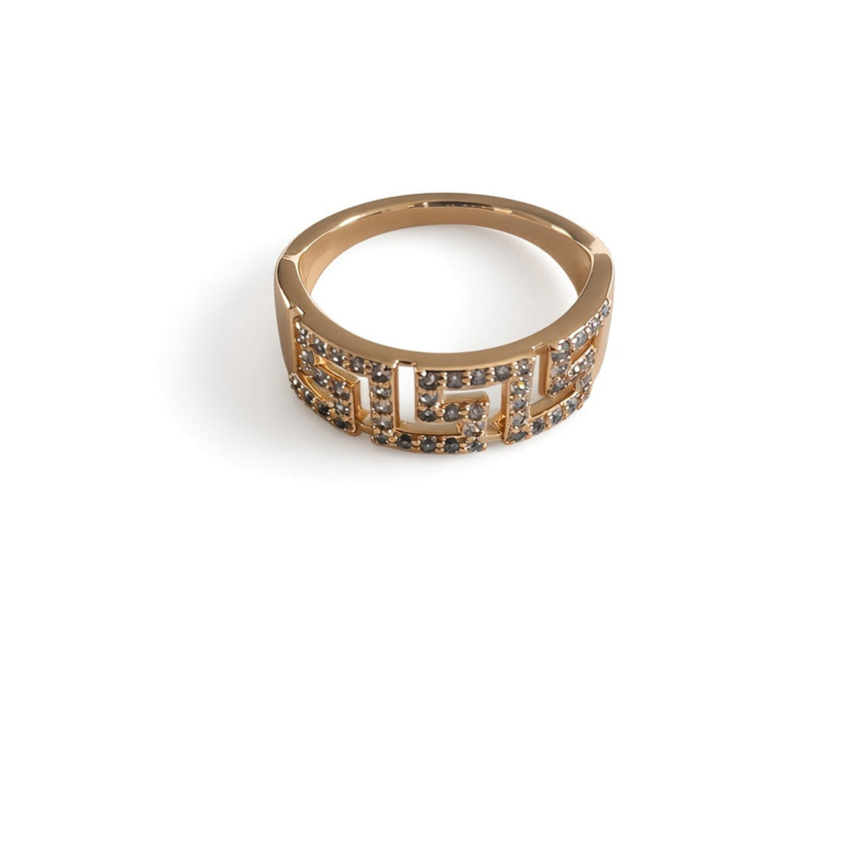 A gold ring with a wide band featuring a geometric pattern paved with small clear gemstone stones, luxury design