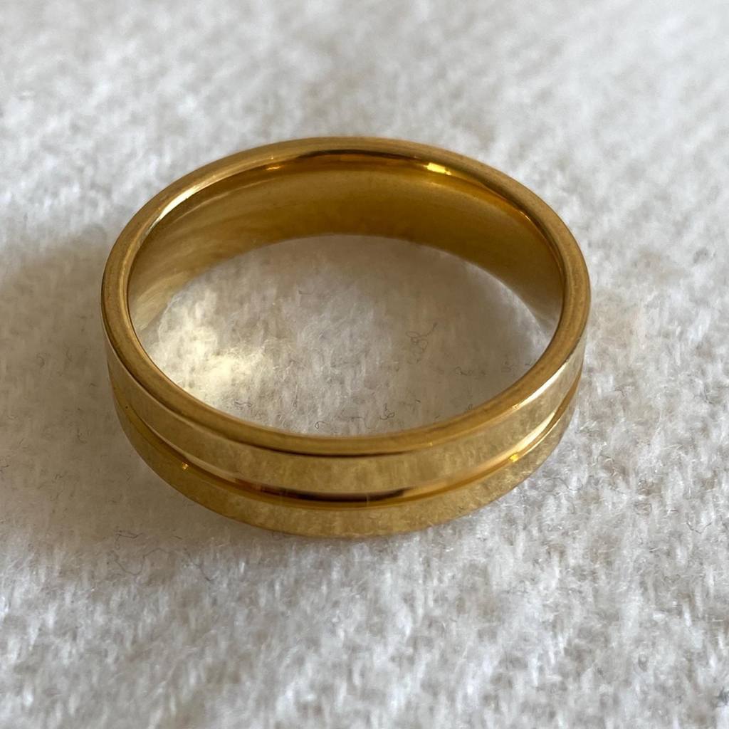 Gold ring on a textured white surface