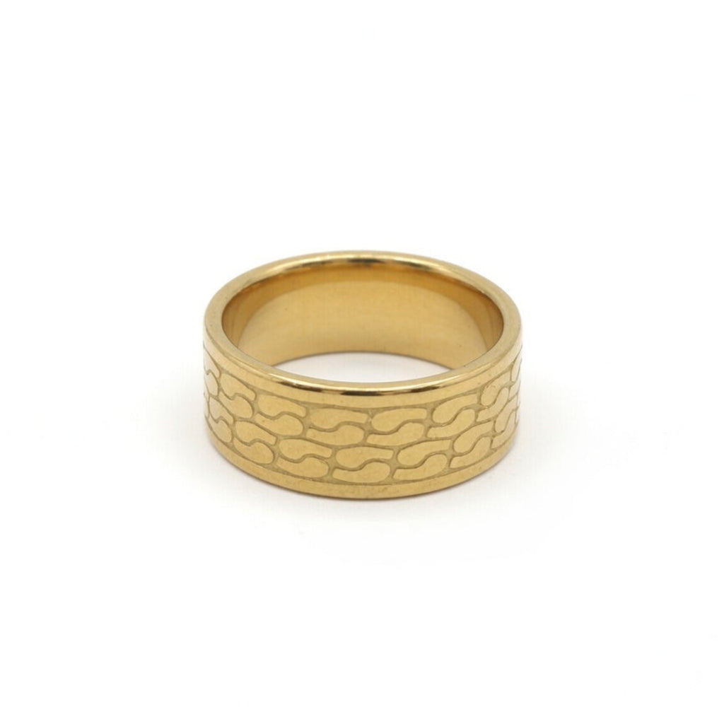 A gold-colored metal ring with a textured, wavy pattern on its outer band, shown against a plain white background.