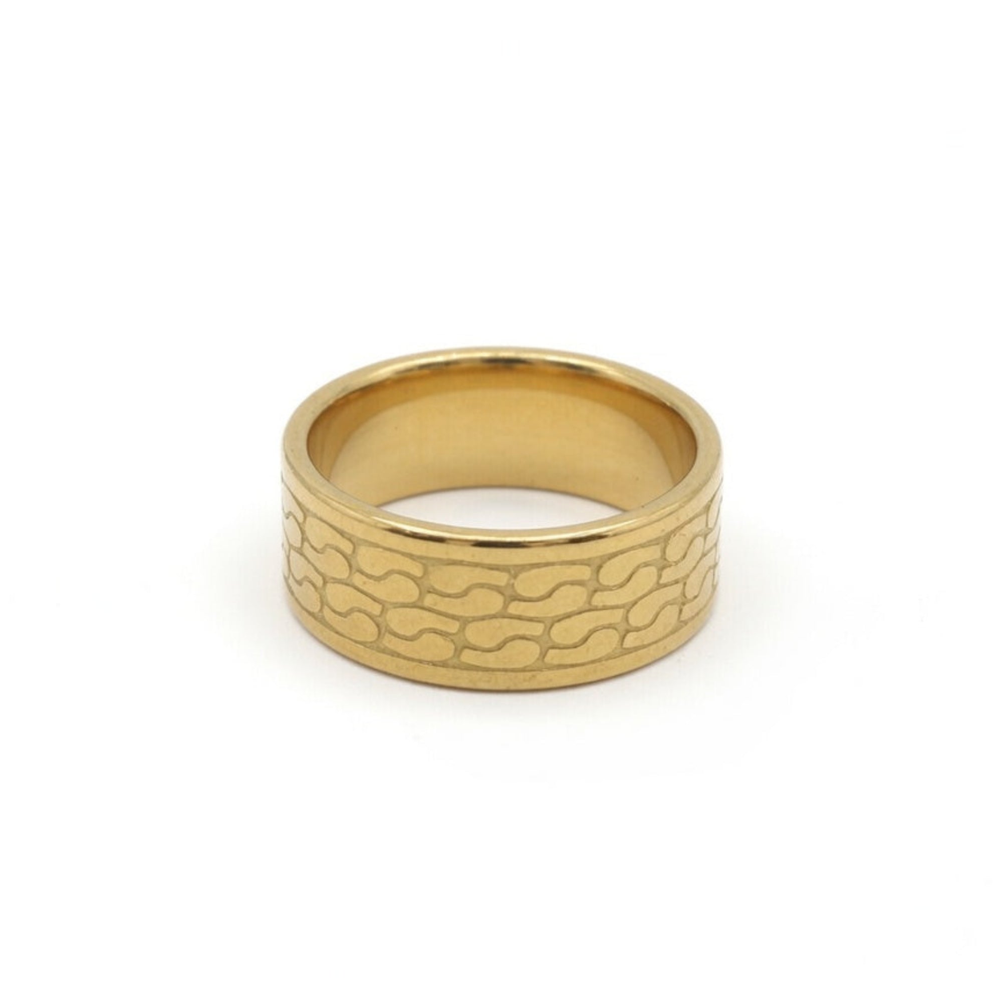 A gold-colored metal ring with a textured, wavy pattern on its outer band, shown against a plain white background.