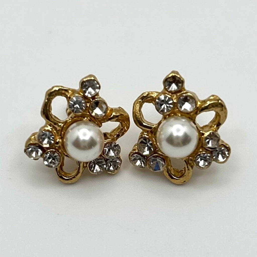 Pair of gold earrings with pearl centers on a white background