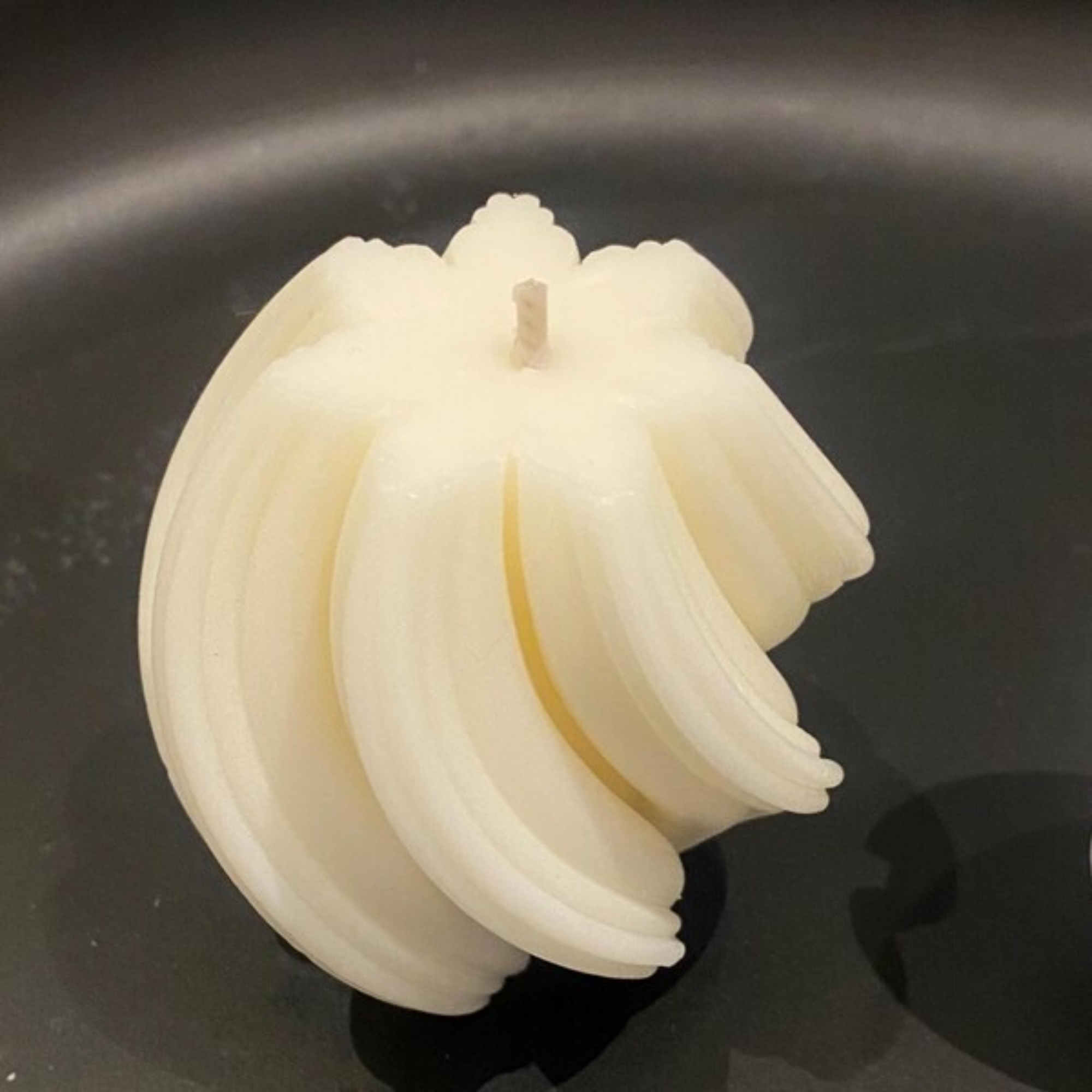 White spiral candle on a black background