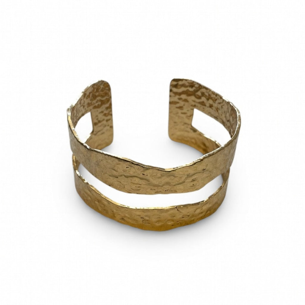 Gold cuff bracelet on a white background
