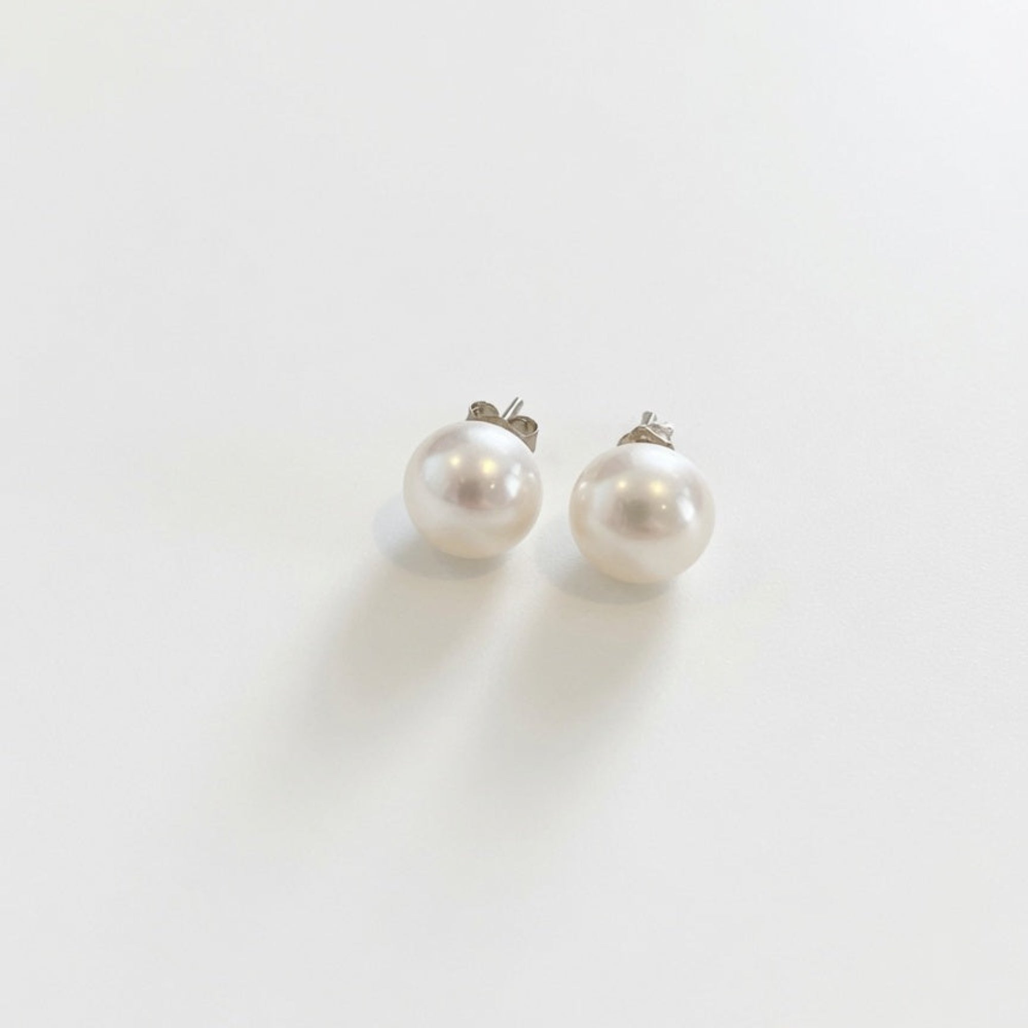 Pair of pearl earrings on a white background, boheme london, freshwater pearl